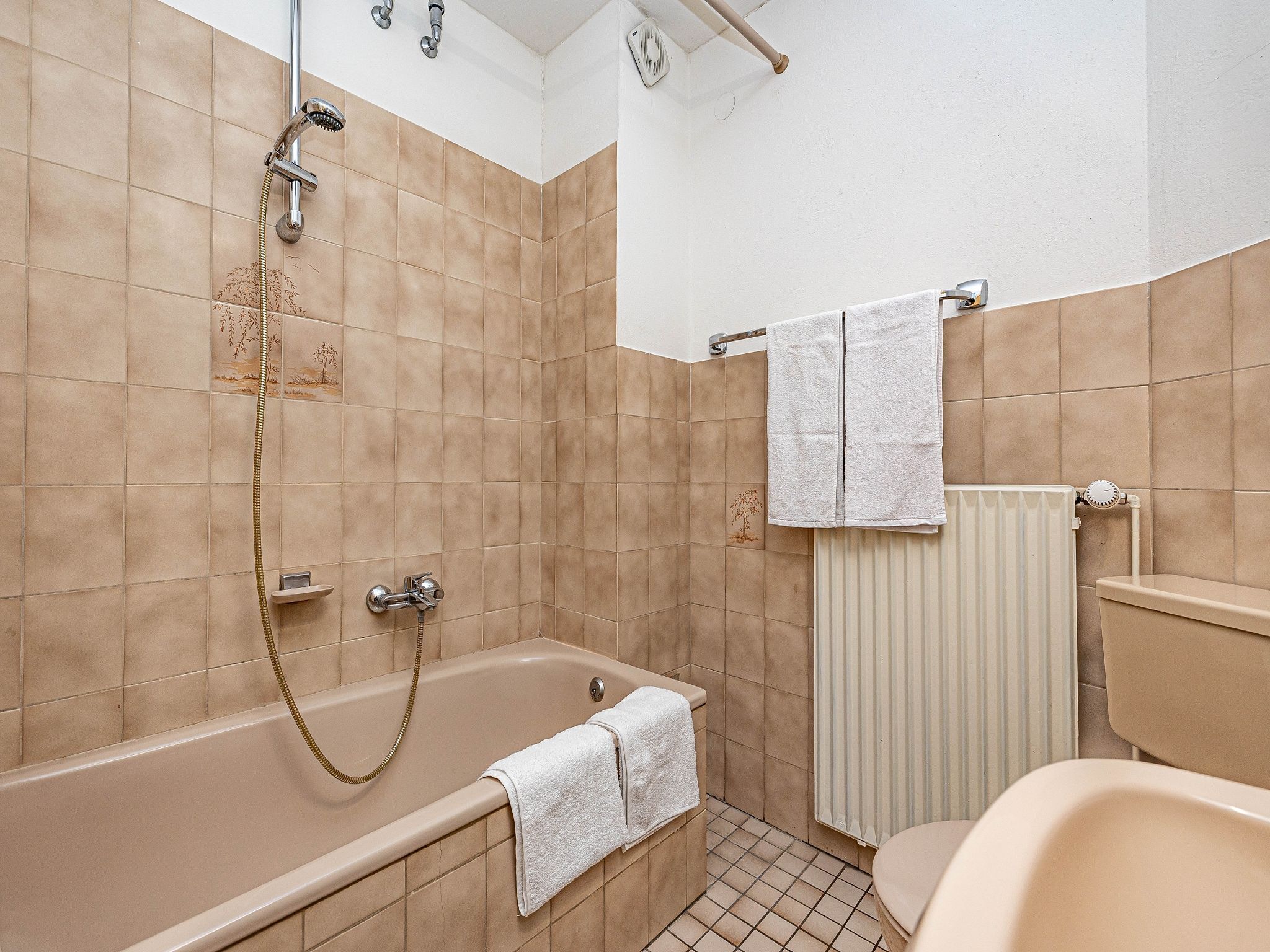 A bathroom with a bathtub, a toilet, and a shower.