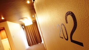 A hallway with a wall displaying the number "202". - HOTEL Rakuserina (Fuefuki)