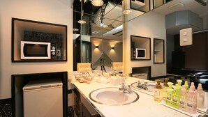 A modern bathroom with a large mirror, a sink, and a microwave. - HOTEL Rakuserina (Fuefuki)