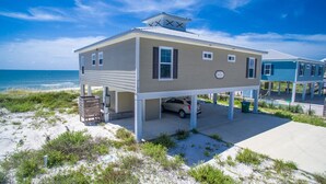 A beachfront house with a covered garage, a small deck, and a view of the ocean. - North end of Cape Gulf Front 1 level w/elevator from carport & screened-in porch (Cape San Blas)
