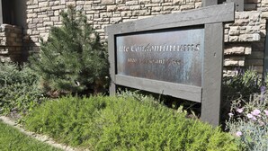 A sign for 'Ute Condominium Estates' with a rustic stone wall and greenery in the foreground. - Ute Condominiums - Central & Cozy (Aspen)