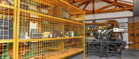 A large industrial space with metal shelving units filled with various mechanical parts and tools.
