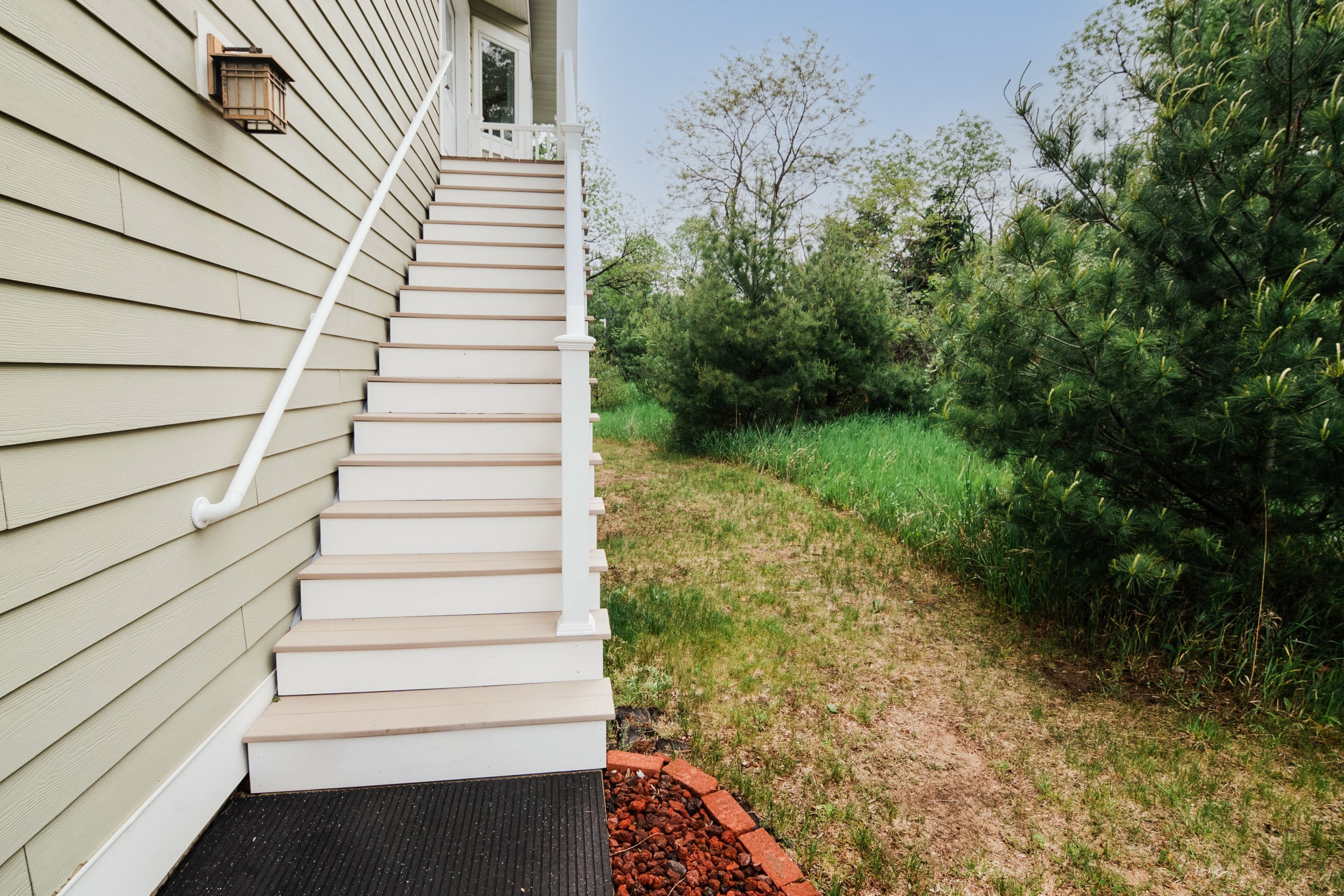 A staircase leading to a house with a porch.