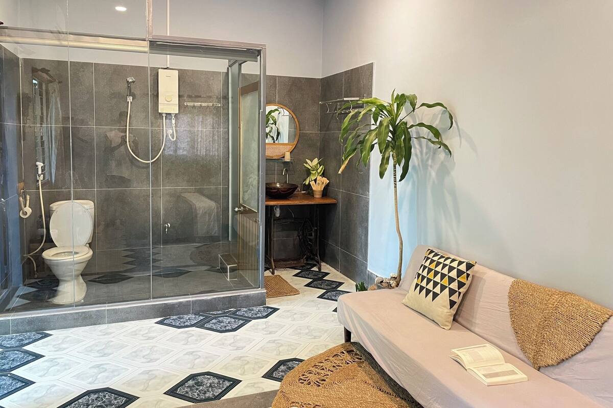 A bathroom with a shower, toilet, and sink.