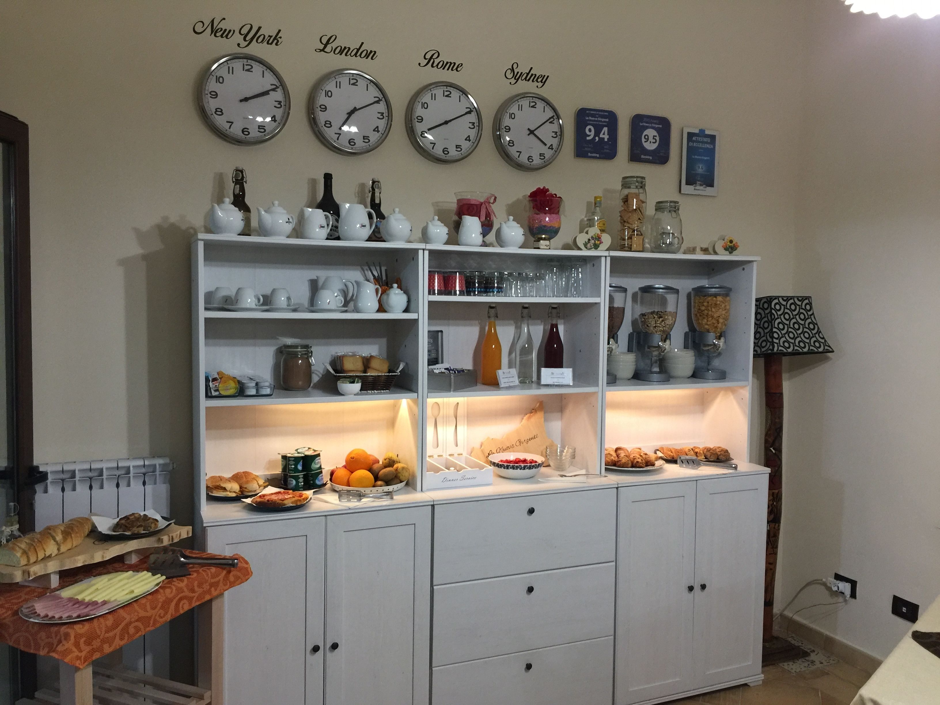 A kitchen with a buffet setup, featuring various food items and kitchenware.