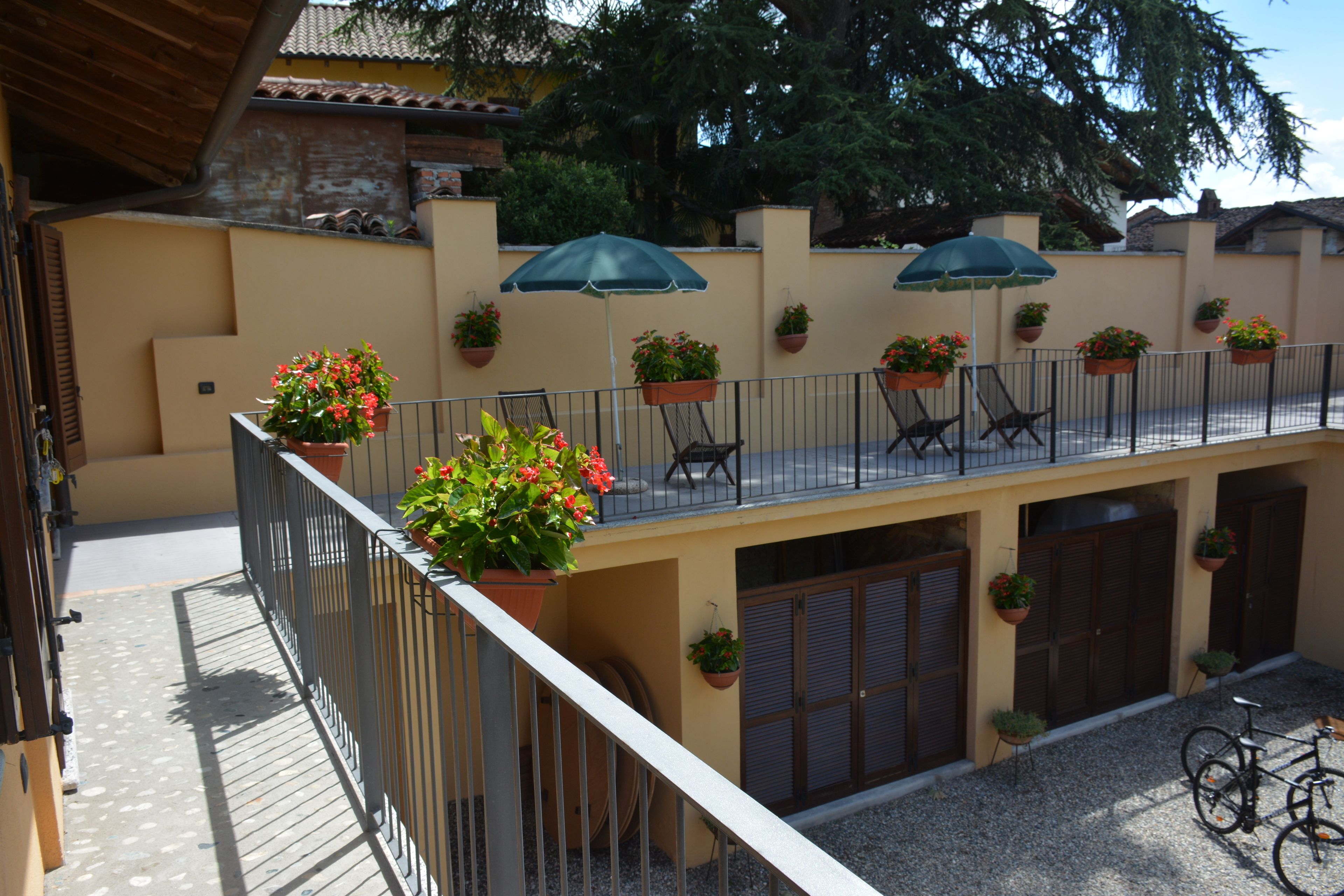 A balcony with potted plants, outdoor furniture, and a bicycle.