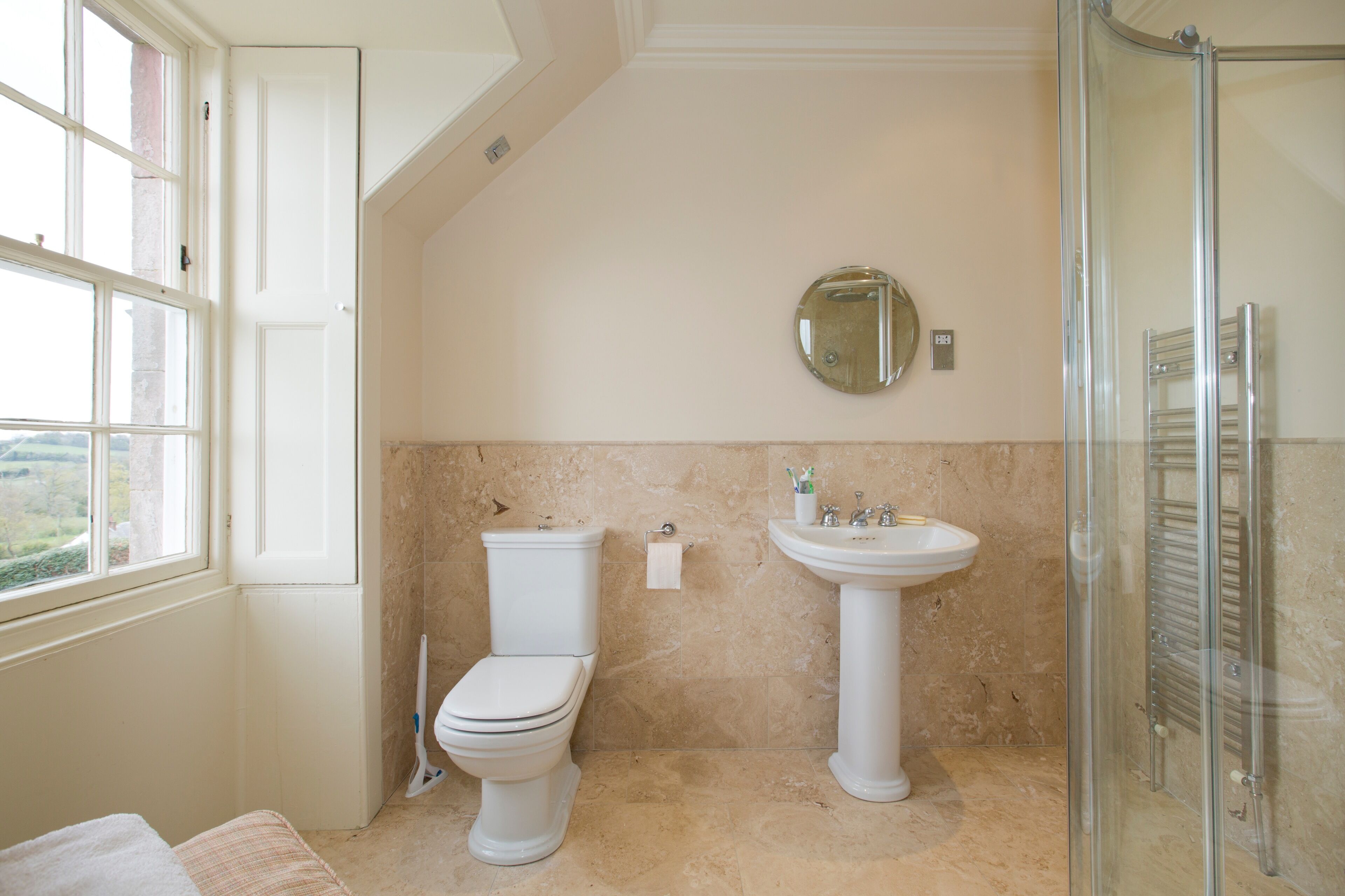 A bathroom with a toilet, sink, and shower.