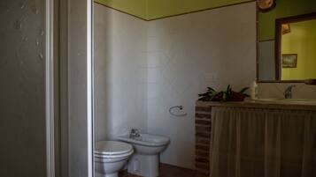 Un bagno con WC, bidet e lavandino.