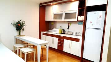 Family Room | Private kitchen | Full-size fridge, microwave, electric kettle, cookware/dishes/utensils