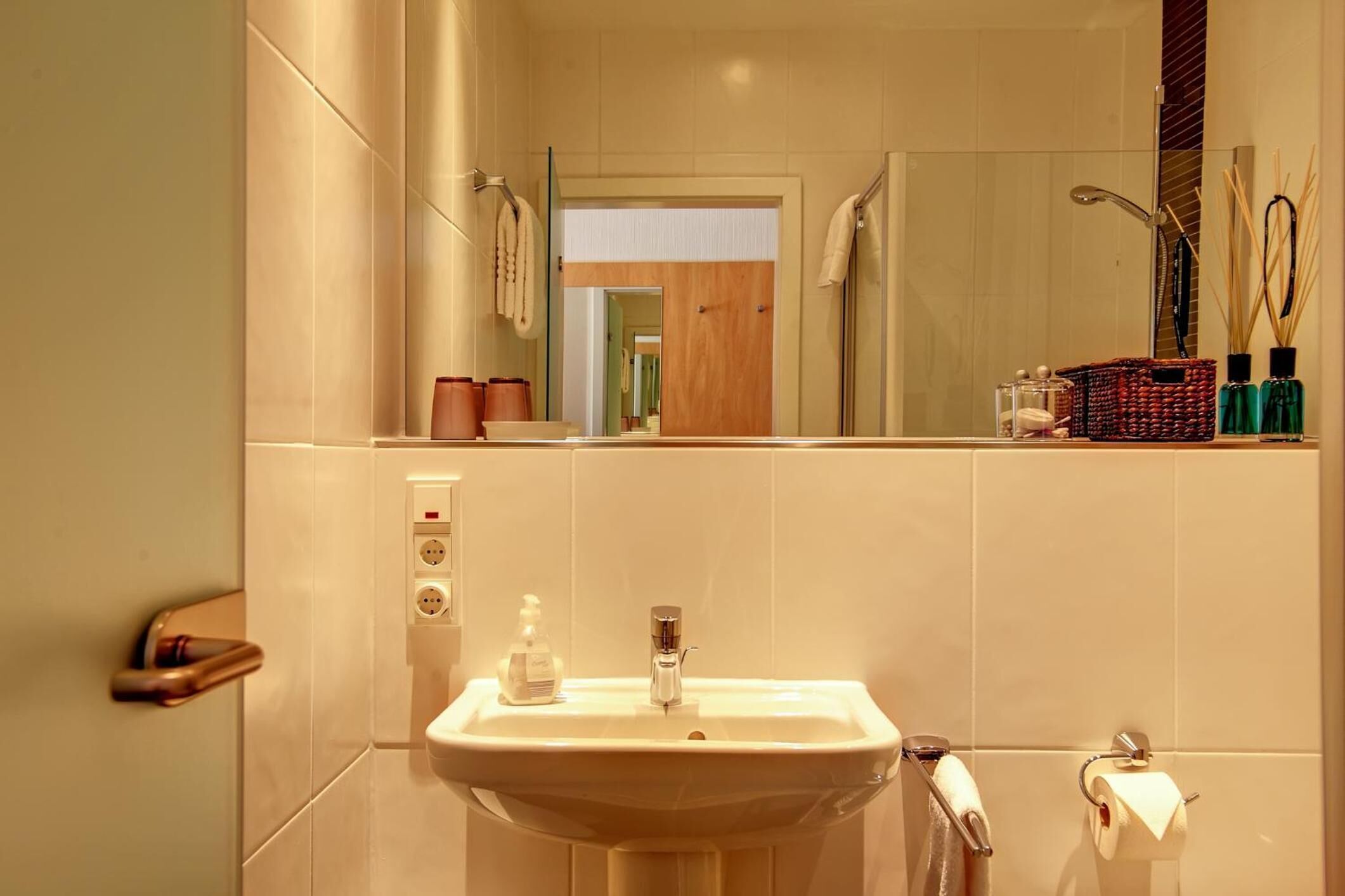 A bathroom with a sink, mirror, and towel rack.