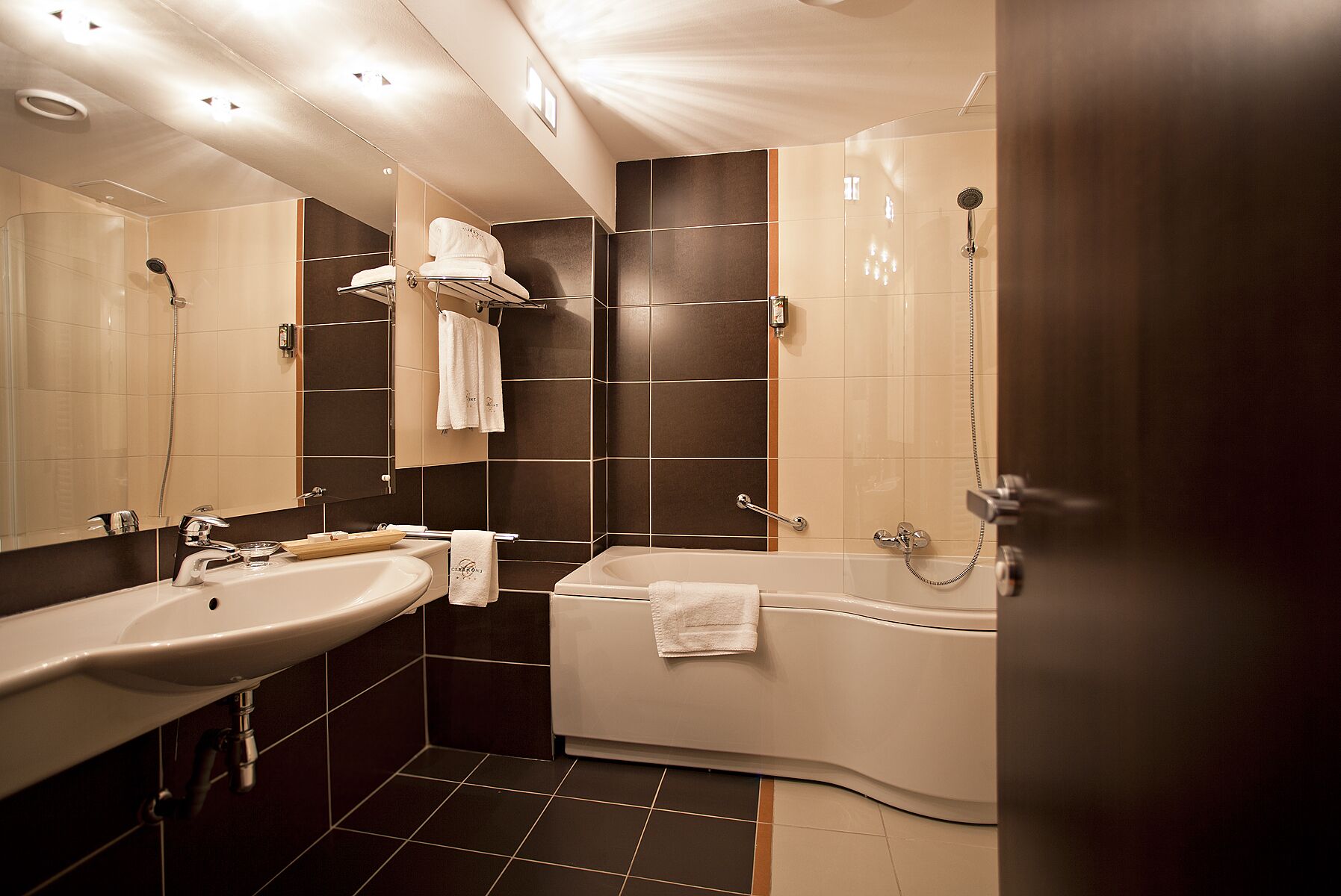 A modern bathroom with a bathtub, a sink, and a shower.