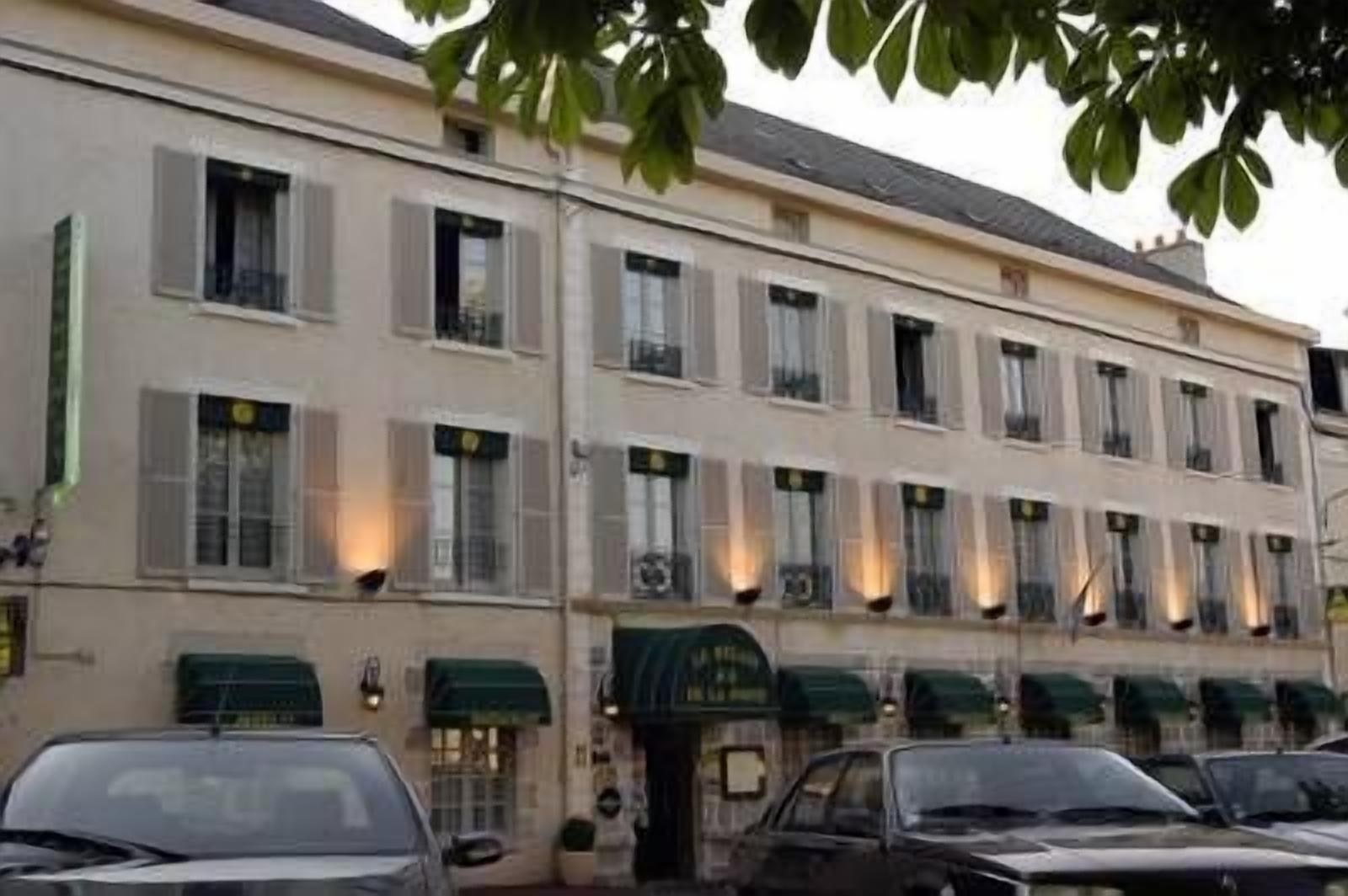A multi-story building with a row of windows and a green awning.