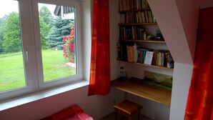 A room with a window, a bookshelf, a desk, and a chair. - Prázdninový dům Pacl (Cervená Recice)
