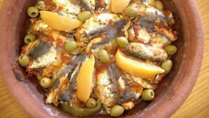 A clay pot filled with grilled sardines, olives, and lemon slices. - Riad Sidi Omar (Marrakech)