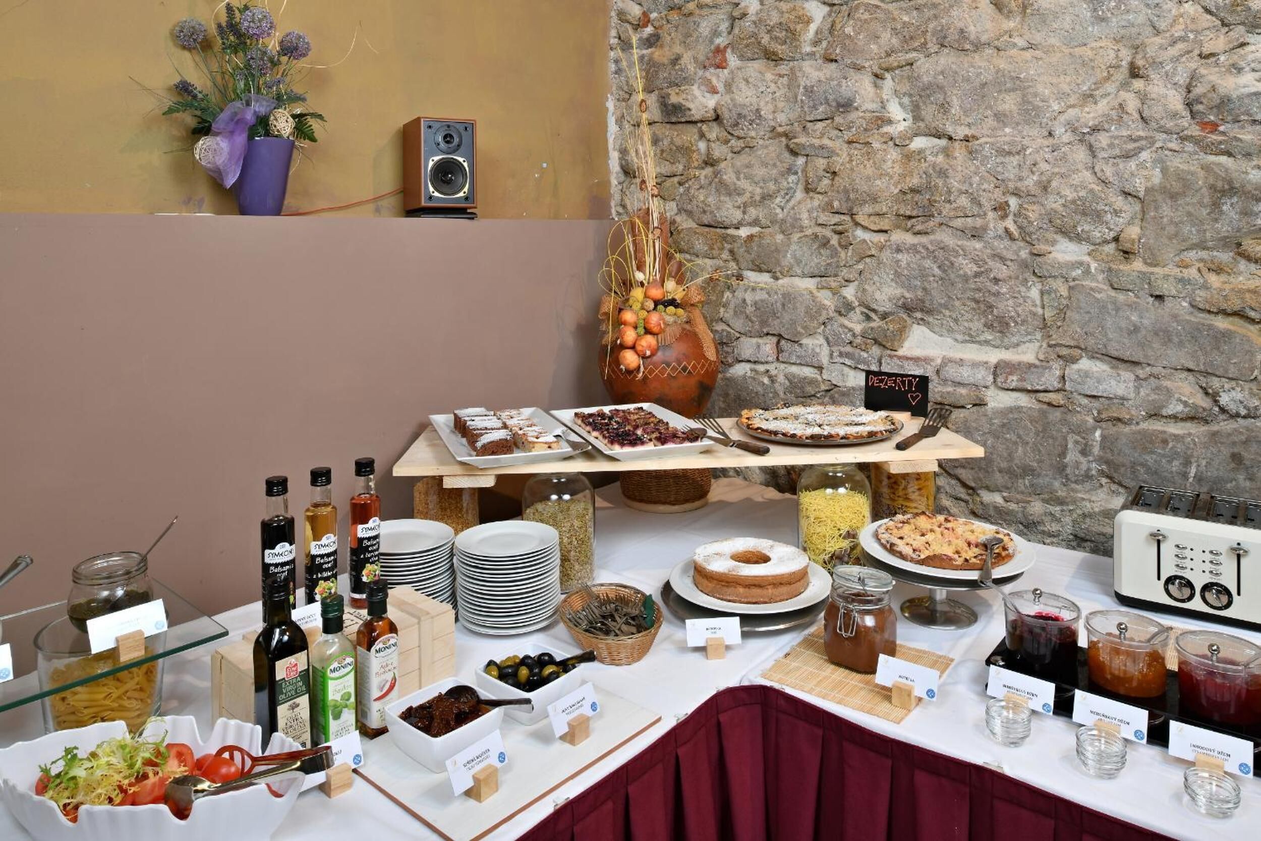 A buffet table with various food items and condiments.