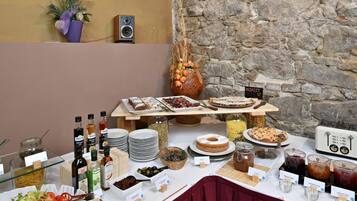 A buffet table with various food items and condiments.