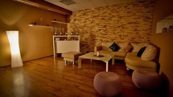 A modern living room with a wooden floor, a sofa set, a coffee table, and a lamp.