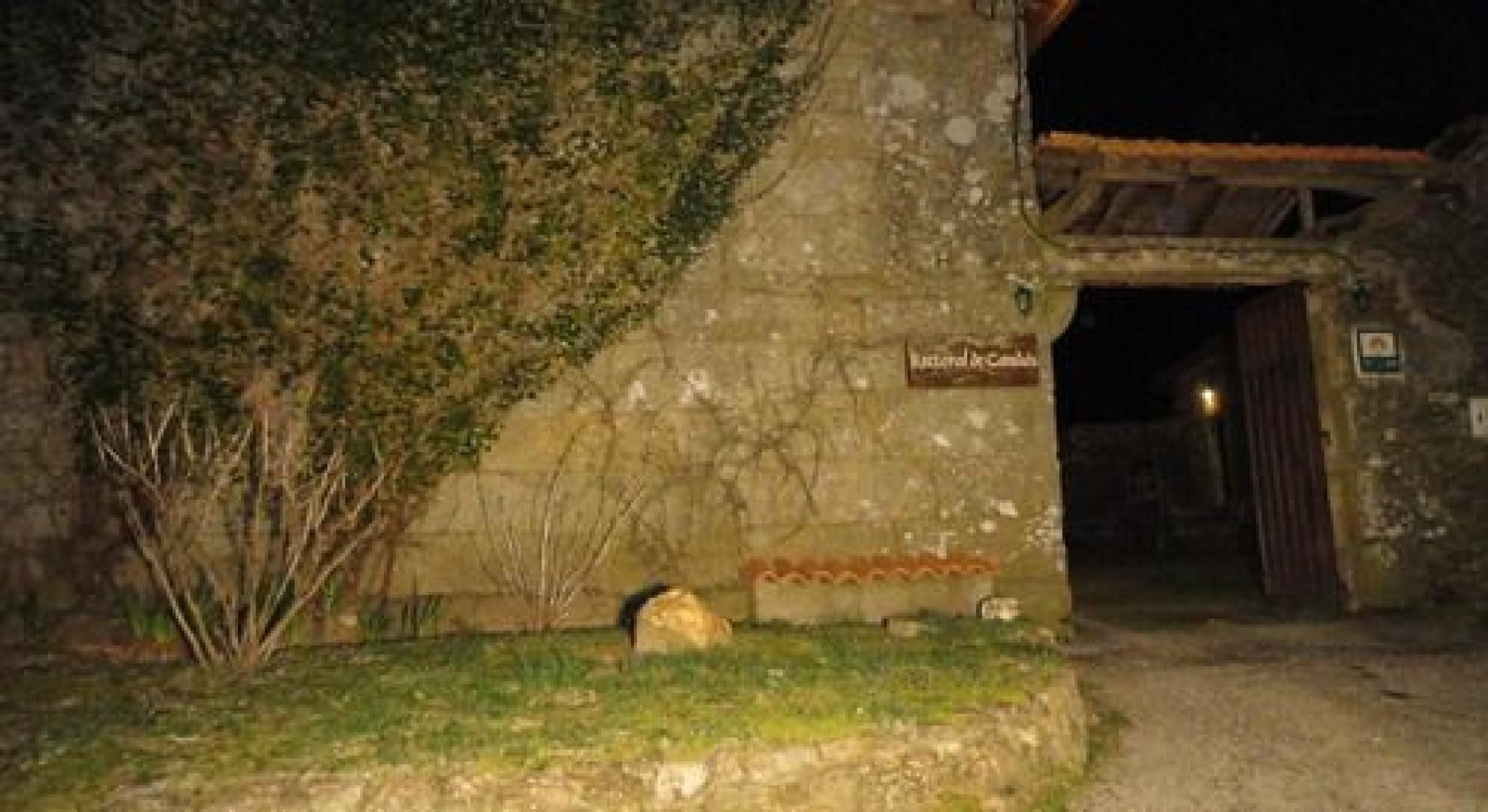 Un edificio de piedra rústico con un letrero que dice "Hotel de la Cueva".