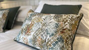 A bed with a patterned pillow and a headboard.
