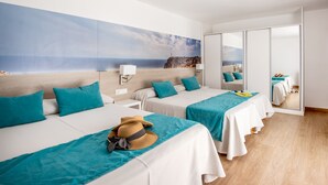 A hotel room with two beds, a large window with a coastal view, and a sliding door leading to a balcony. - Hostal Es Pi (Formentera)
