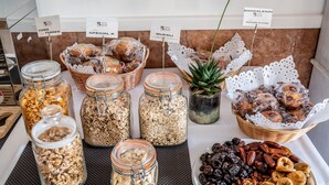A breakfast buffet with various food items including cereals, nuts, and pastries. - Hostal Es Pi (Formentera)