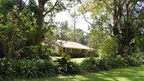 A house surrounded by lush greenery and a well-maintained lawn. - Rondo Retreat Centre (Kakamega)