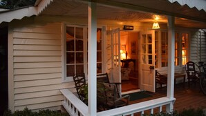 A cozy porch with wicker chairs and a table, a door labeled "TURTONS," and a bicycle parked outside. - Rondo Retreat Centre (Kakamega)