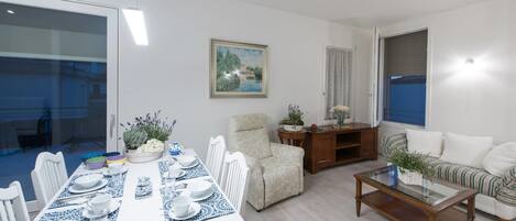 Una sala moderna con comedor, un sofá y una mesa de centro.