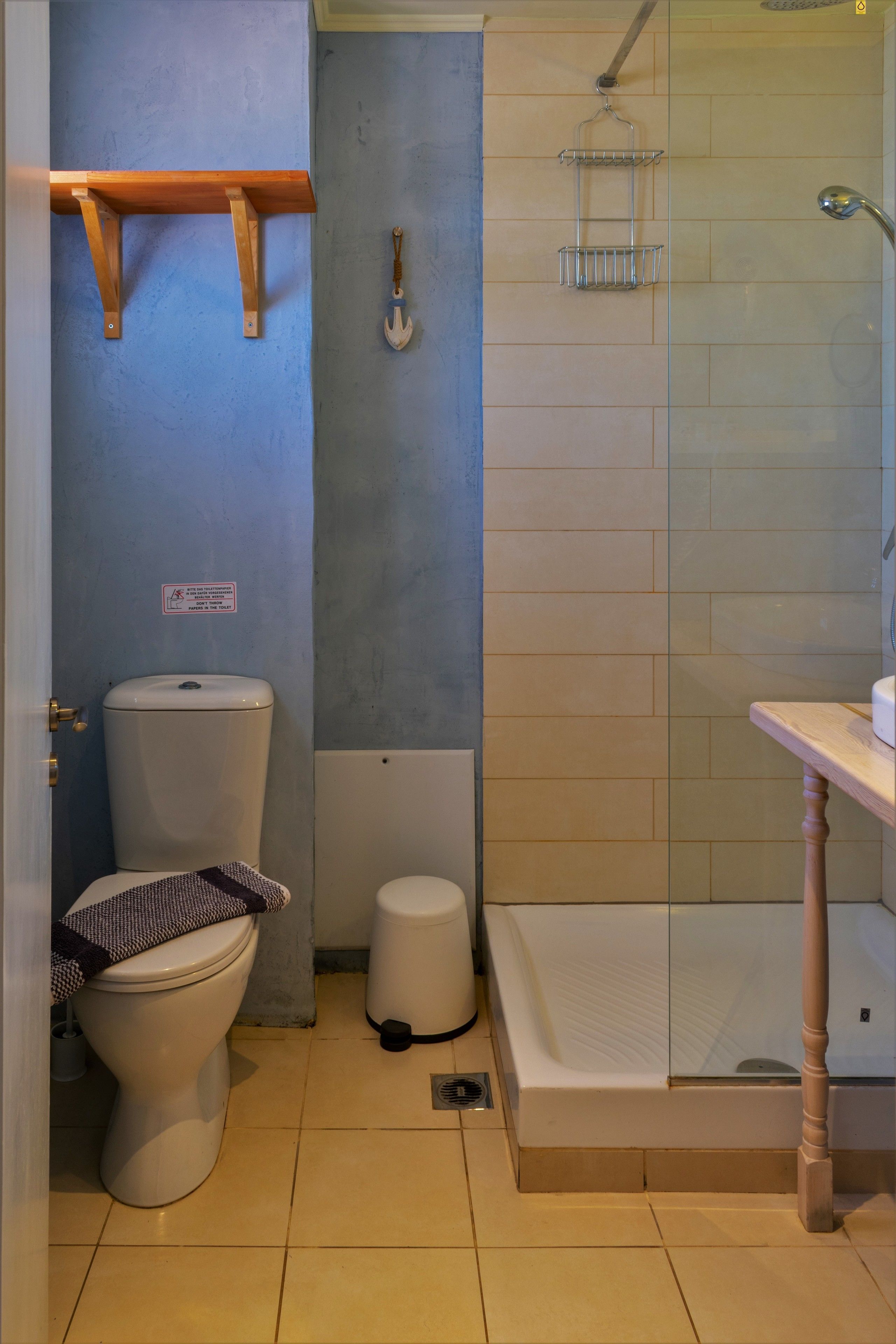 A bathroom with a toilet, a bidet, a shower, and a sink.