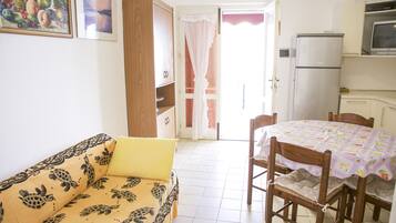 Apartment | Private kitchen | Fridge, stovetop, cookware/dishes/utensils, dining tables