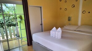 Une chambre d’hôtel avec un lit, une porte et une vue sur l’extérieur.