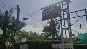 A signboard for a Sport Bar Resort & Restaurant, open from 09:00 to 10:00 pm.