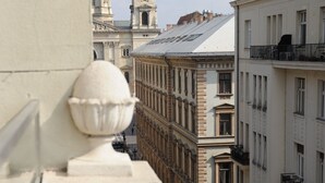 A view of a street with buildings, including a prominent tower with a clock. - Budapest Easy Flat - Basilica Lux (Budapest)