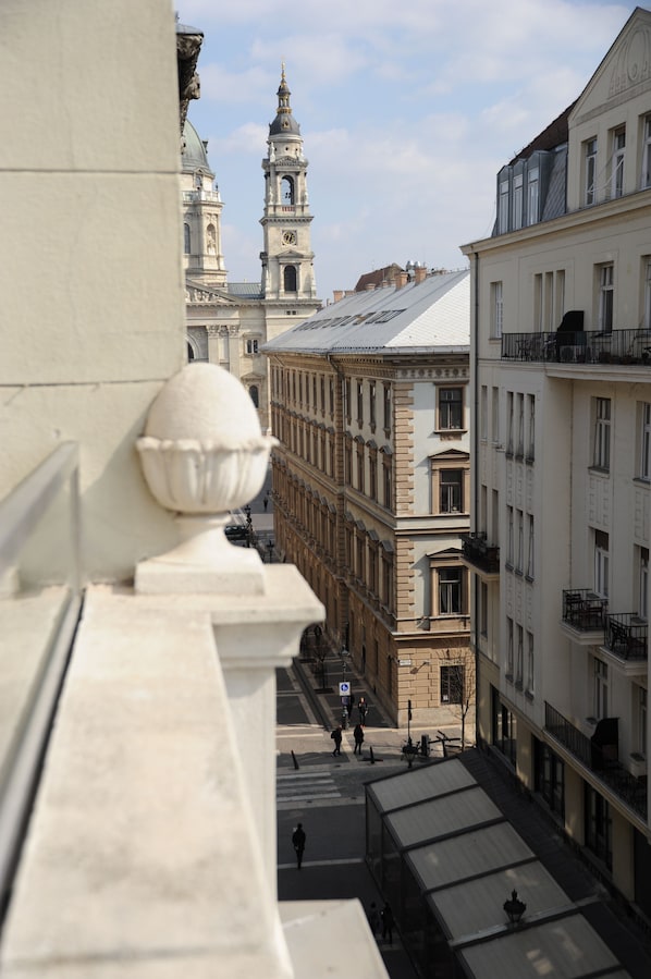 A view of a street with buildings, including a prominent tower with a clock.