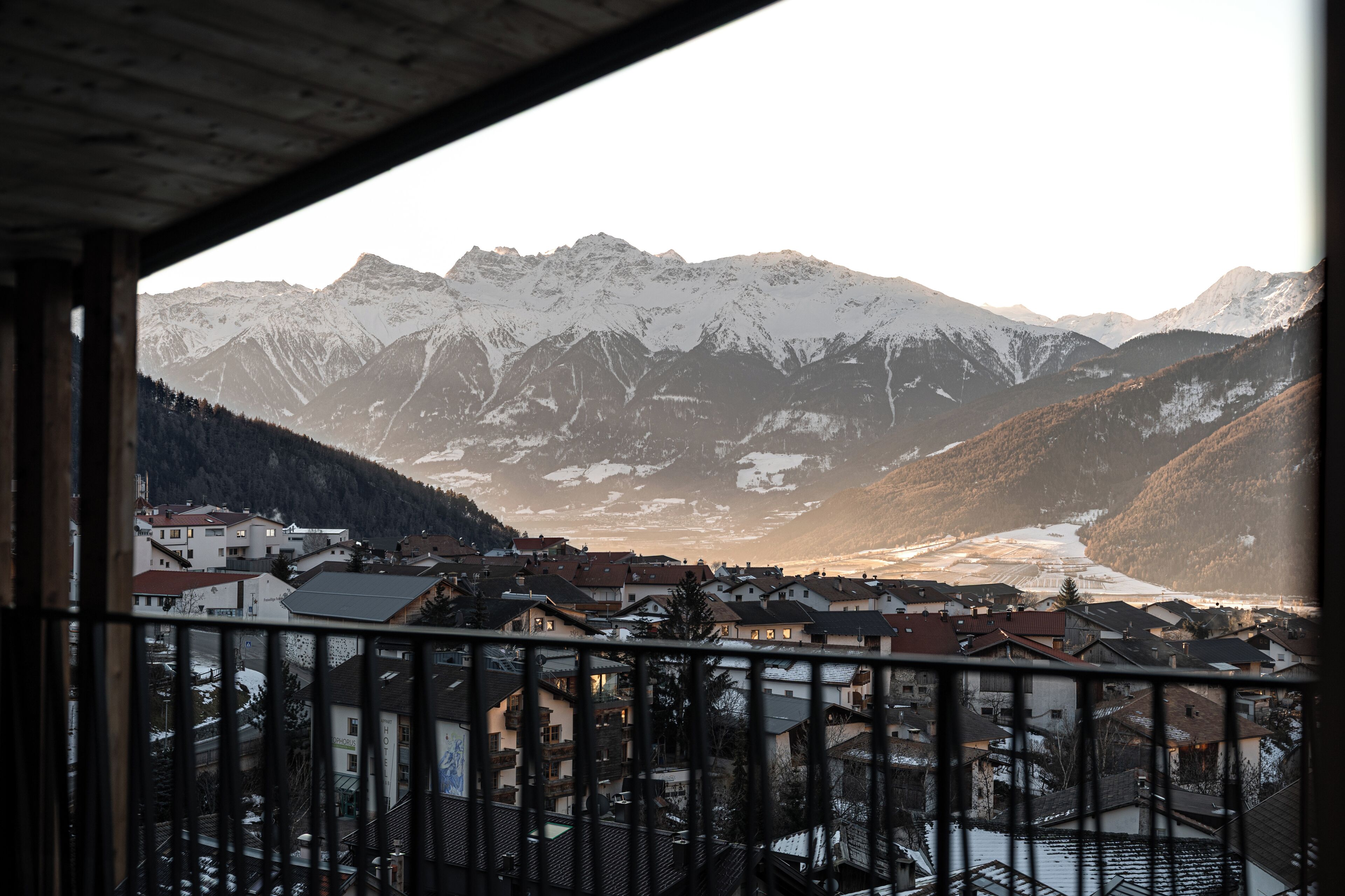 A mountain town with snow-capped peaks and a river valley.