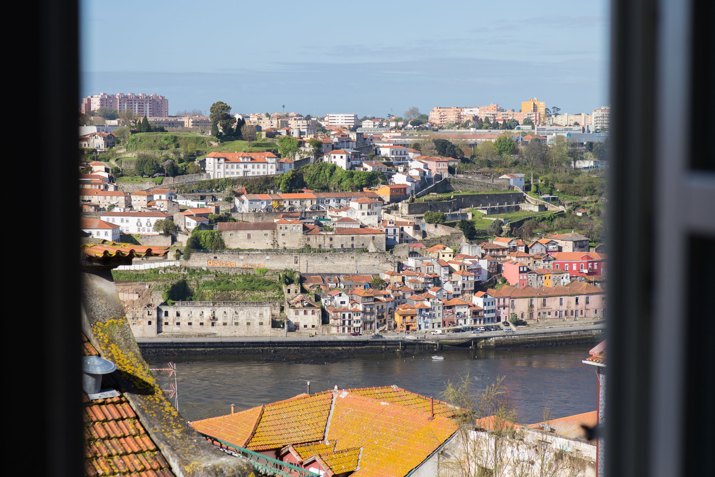 A coastal town with historic buildings and a river.