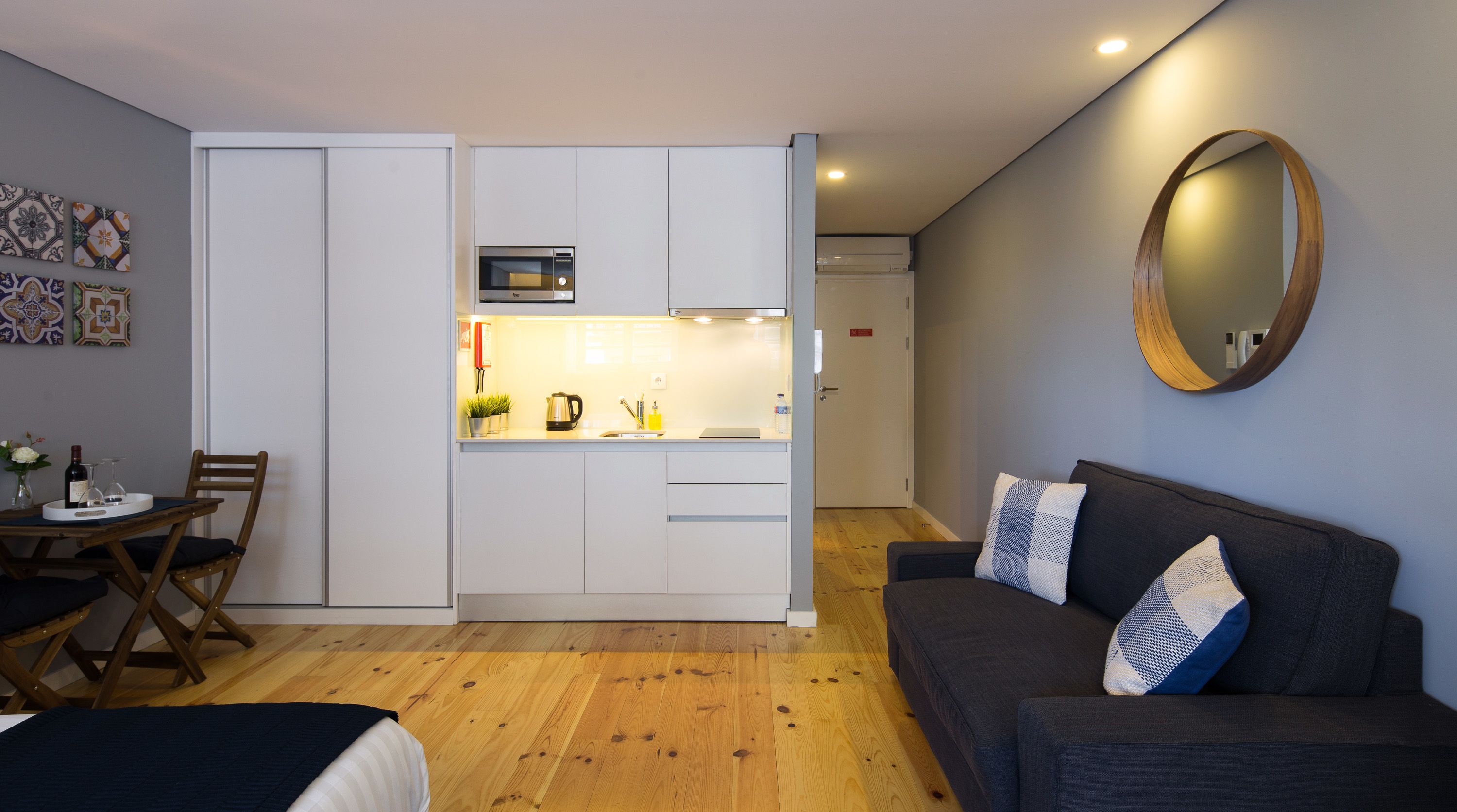 A compact living space with a kitchenette, a dining area, and a seating area.