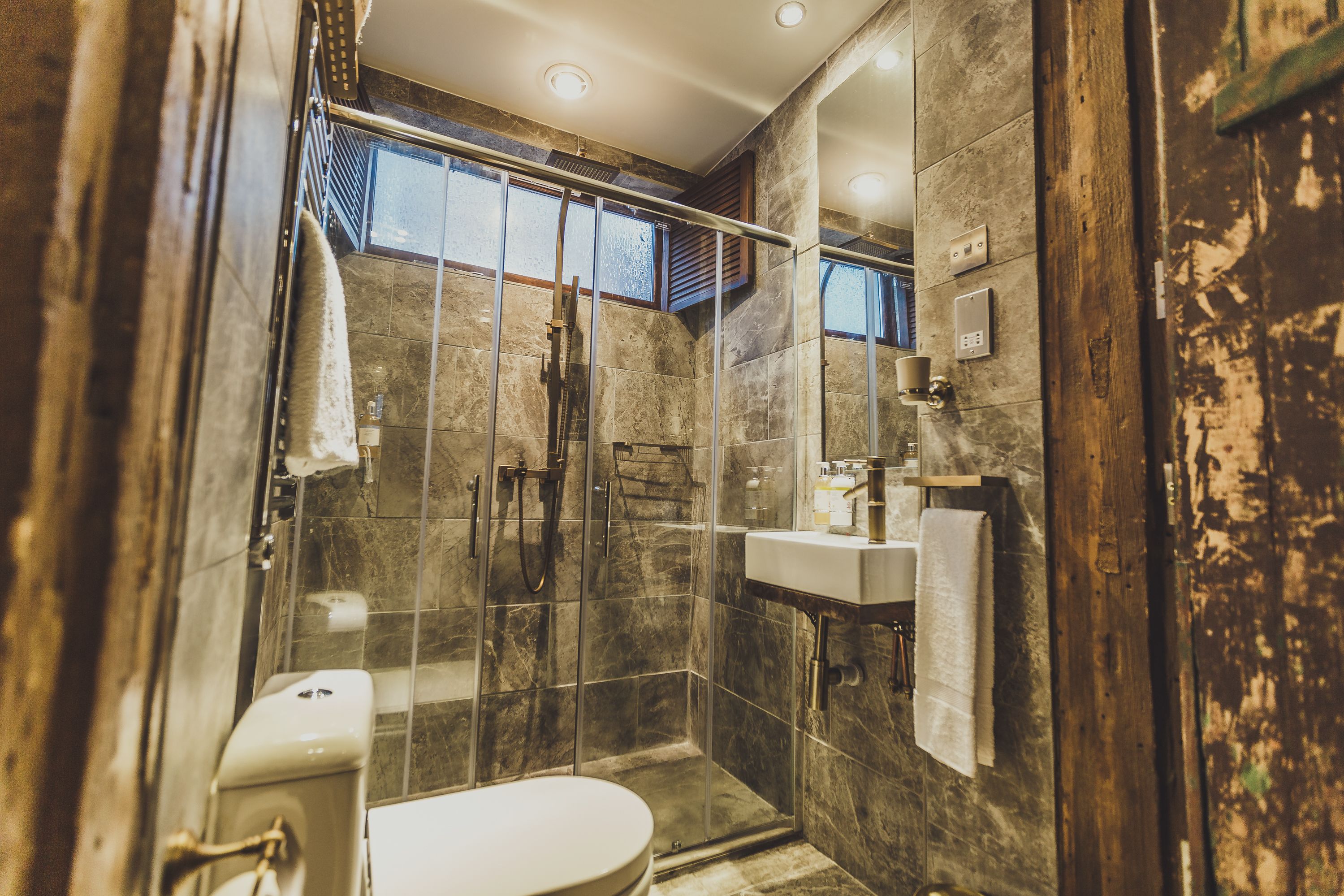 shower, rainfall showerhead, designer toiletries, slippers