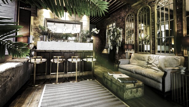 A cozy interior with a bar area, seating, and decorative plants. - The Cow Hollow Hotel (Manchester)