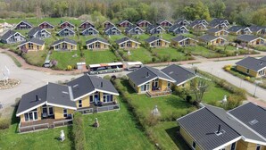 A residential area with multiple houses, some with attached garages, and a bus parked in the driveway. - Nice home in Rechlin with sauna (Rechlin)