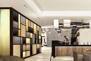 A modern kitchen with a bar area, wooden cabinets, and a person preparing food. - Ac Hotel Venezia by Marriott (Venice)
