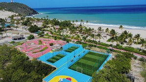 An aerial view of a resort with a beach, a lighthouse, and a colorful sports complex. - Sunsol Ecoland (Matasiete)