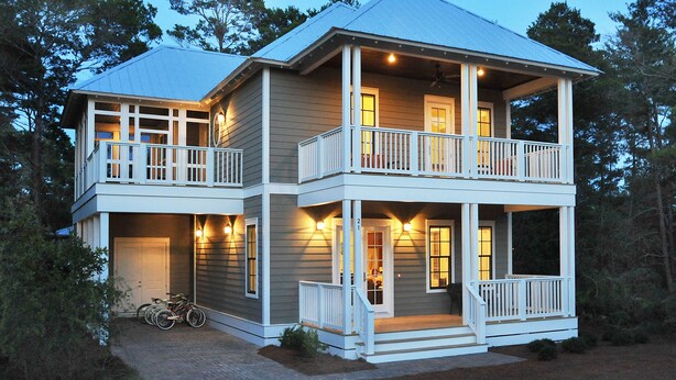 A two-story house with a balcony on the upper level, a covered porch on the lower level, and a bicycle parked outside. - Crosswinds Beach House - 4BR home by 30A, bikes included! (Santa Rosa Beach)
