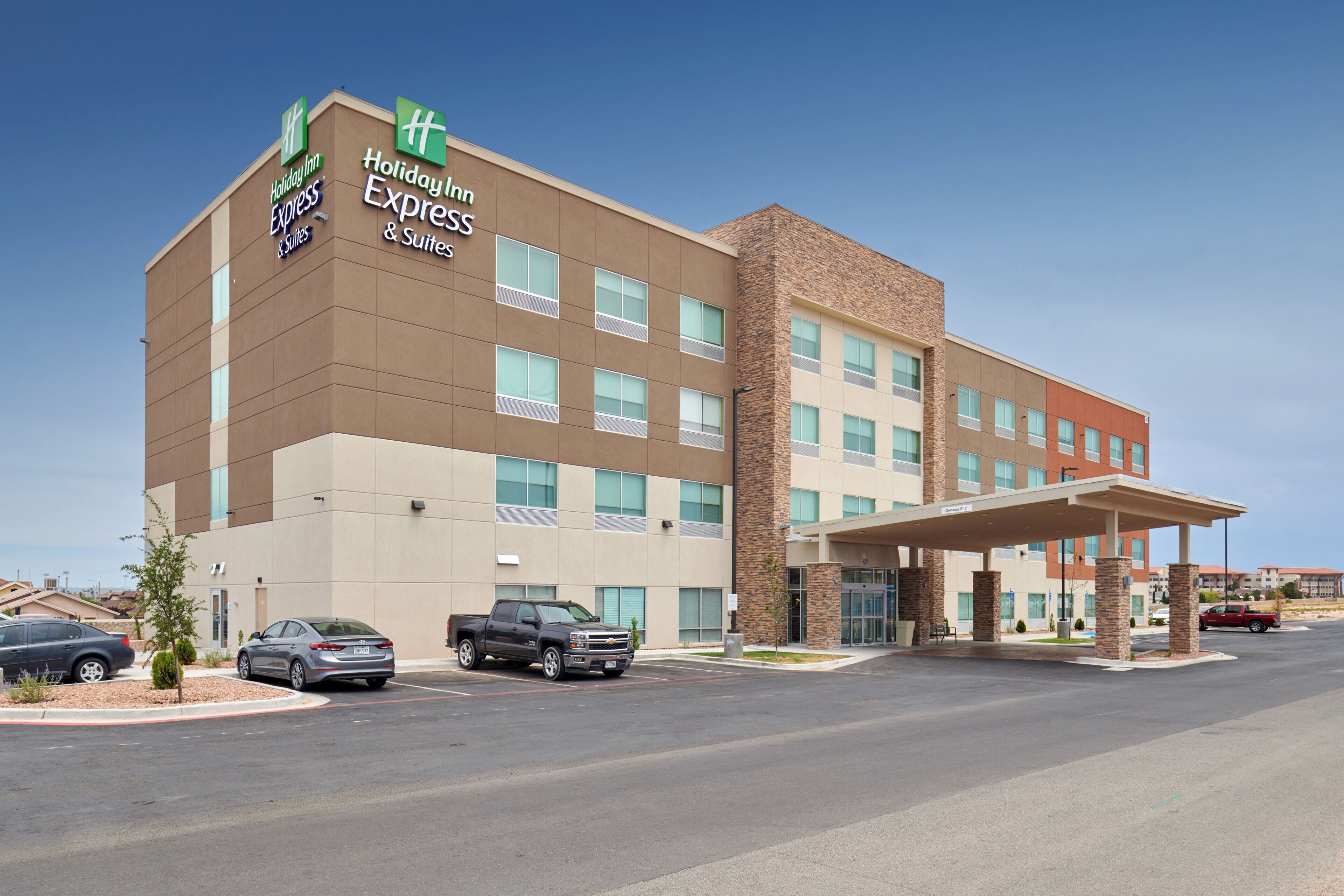 A Holiday Inn Express & Suites hotel with a parking lot and a covered entrance.