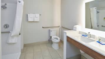 A modern bathroom with a shower, toilet, and sink.