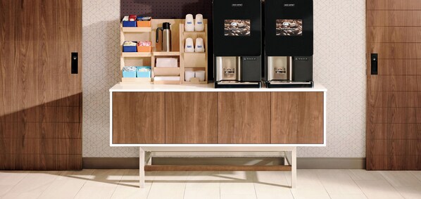 A wooden counter with storage compartments and two coffee machines. - Holiday Inn Express & Suites Hannibal - Medical Center by IHG (Hannibal)