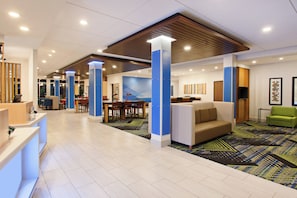 A spacious lobby with a reception desk, seating area, and a large wall mural. - Holiday Inn Express & Suites Moses Lake by IHG (Moses Lake)