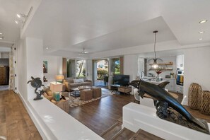 A spacious living area with a sofa, coffee table, and decorative items.
