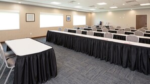 A conference room with multiple tables and chairs, carpeted flooring, and large windows. - Holiday Inn Express and Suites Kalamazoo West by IHG (Kalamazoo)