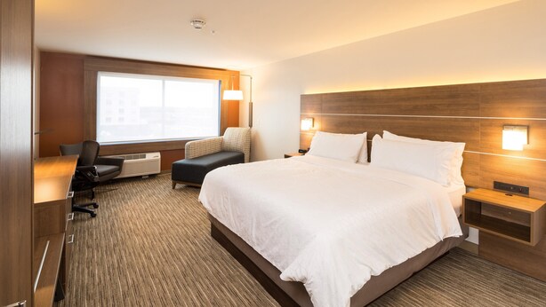 A hotel room with a large bed, a desk, a chair, and a window. - Holiday Inn Express and Suites Kalamazoo West by IHG (Kalamazoo)